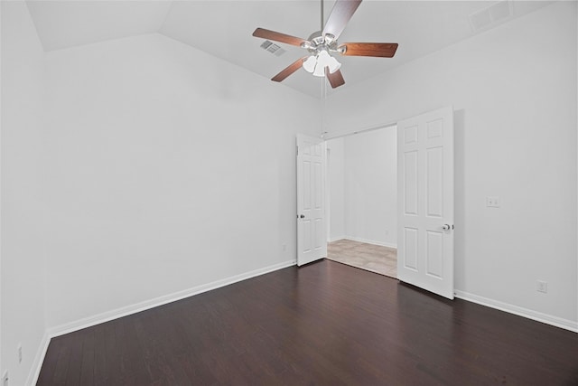 unfurnished bedroom featuring vaulted ceiling, dark hardwood / wood-style floors, ceiling fan, and a closet