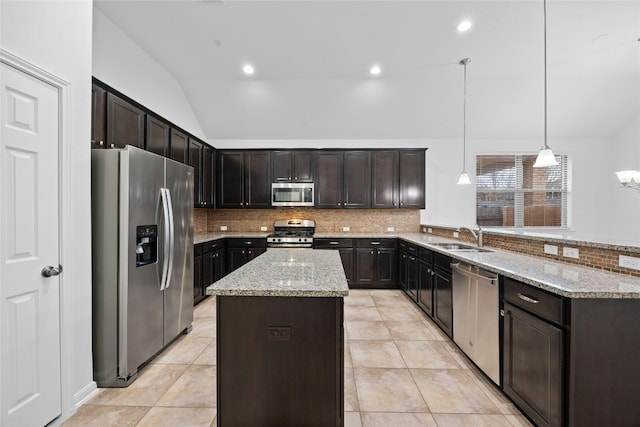 kitchen with sink, appliances with stainless steel finishes, dark brown cabinets, a kitchen island, and decorative light fixtures