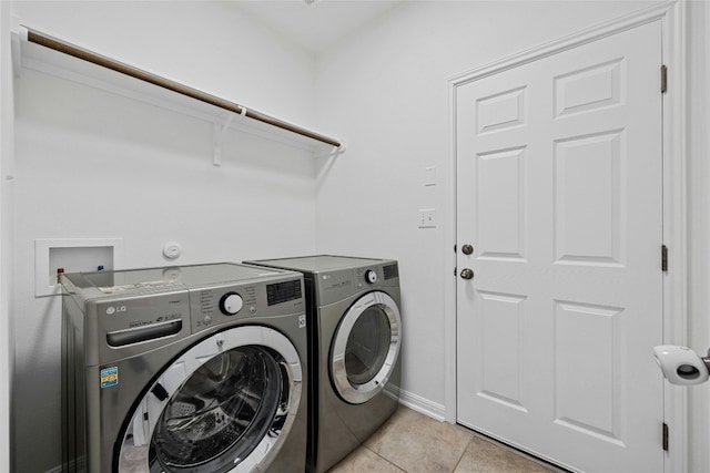 laundry room with light tile patterned flooring and separate washer and dryer