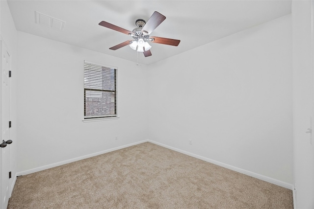 carpeted spare room with ceiling fan