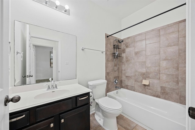 full bathroom with tiled shower / bath, vanity, toilet, and tile patterned floors