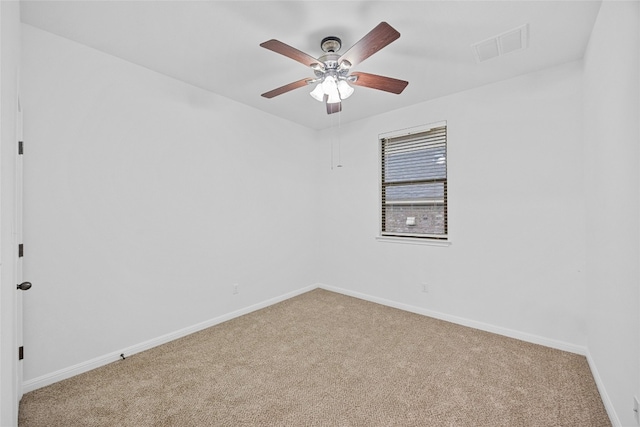 carpeted spare room with ceiling fan