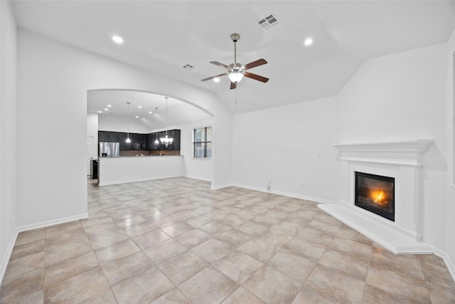 unfurnished living room featuring vaulted ceiling and ceiling fan