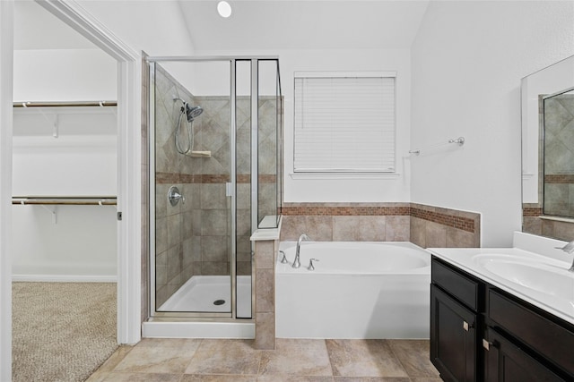 bathroom featuring vanity and independent shower and bath