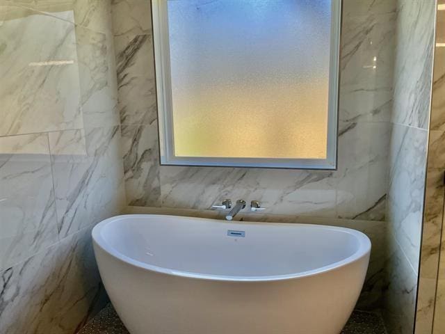 bathroom with a tub to relax in