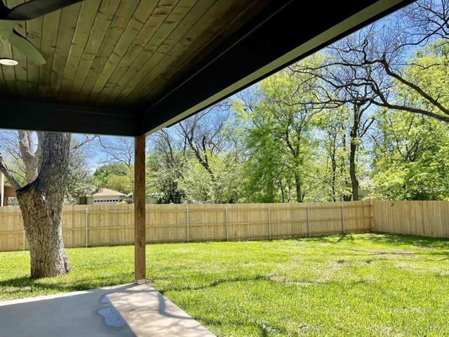 view of yard featuring a patio area and ceiling fan