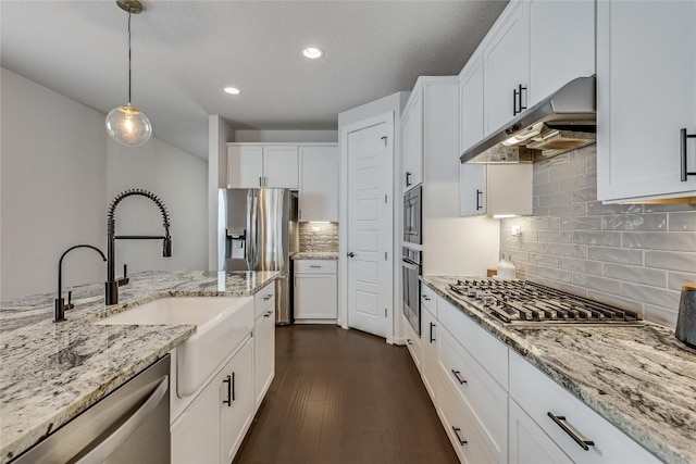 kitchen featuring pendant lighting, white cabinetry, sink, dark hardwood / wood-style flooring, and stainless steel appliances