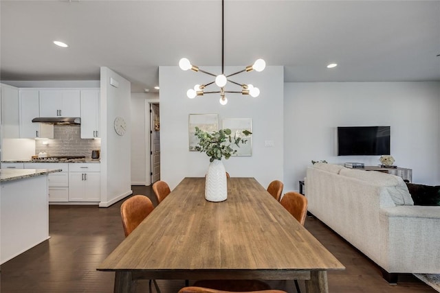 dining space featuring an inviting chandelier and dark hardwood / wood-style flooring