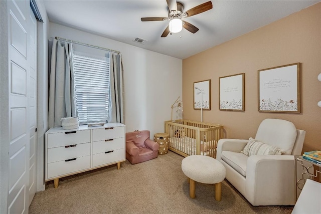 living area with ceiling fan and light colored carpet