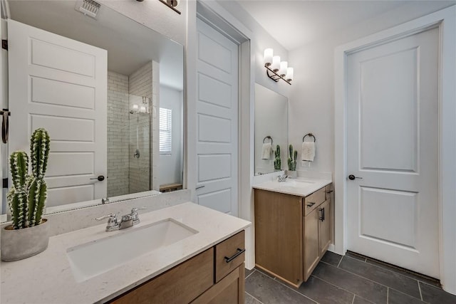 bathroom featuring vanity, tile patterned flooring, and a shower with door