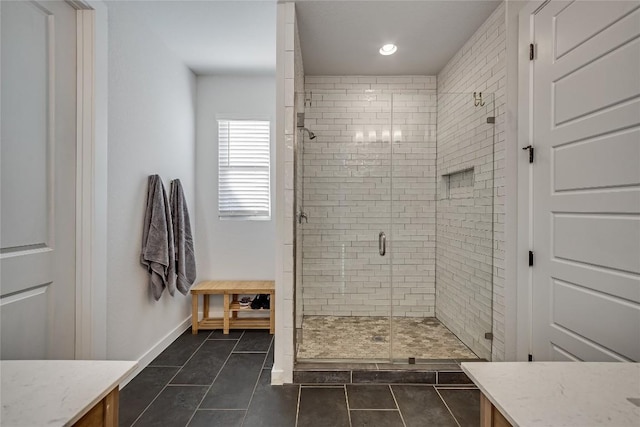 bathroom with tile patterned floors, a shower with shower door, and vanity