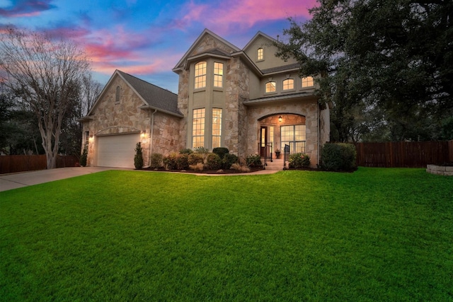 view of front of property featuring french doors, a garage, and a yard