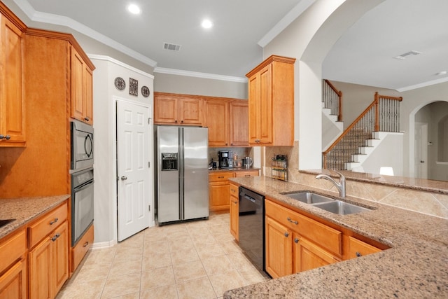 kitchen with sink, crown molding, black appliances, and light stone countertops