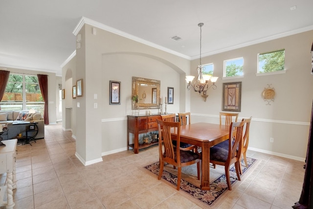 dining room with ornamental molding, light tile patterned floors, and a notable chandelier