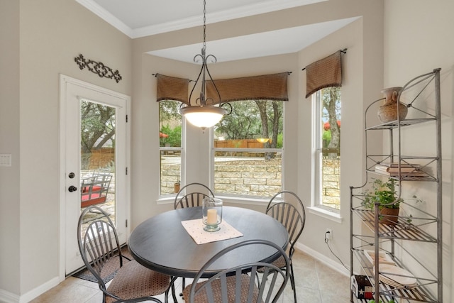 tiled dining area with crown molding and plenty of natural light