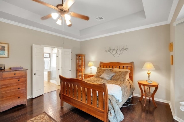 bedroom featuring crown molding, dark hardwood / wood-style floors, and a raised ceiling