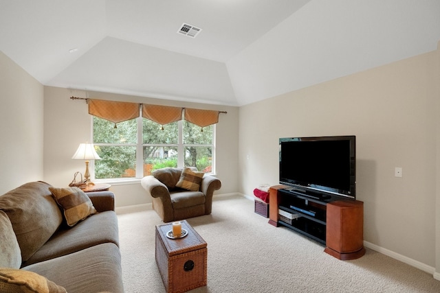 carpeted living room featuring lofted ceiling