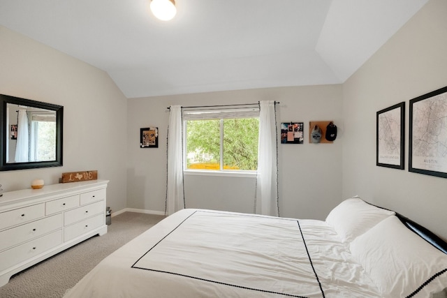 carpeted bedroom featuring vaulted ceiling