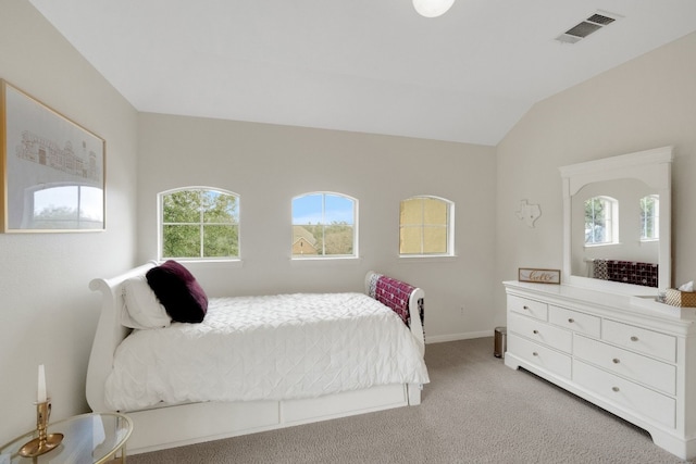 carpeted bedroom featuring lofted ceiling