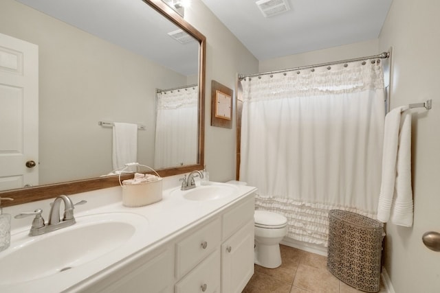 bathroom with tile patterned flooring, vanity, a shower with curtain, and toilet