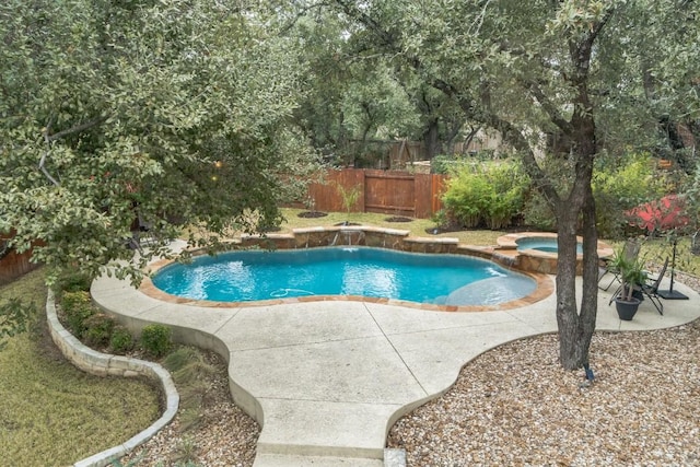 view of pool featuring a patio and an in ground hot tub