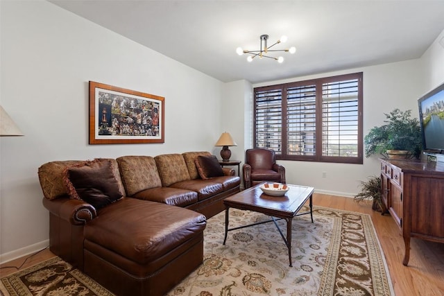 living room featuring an inviting chandelier and light wood-type flooring