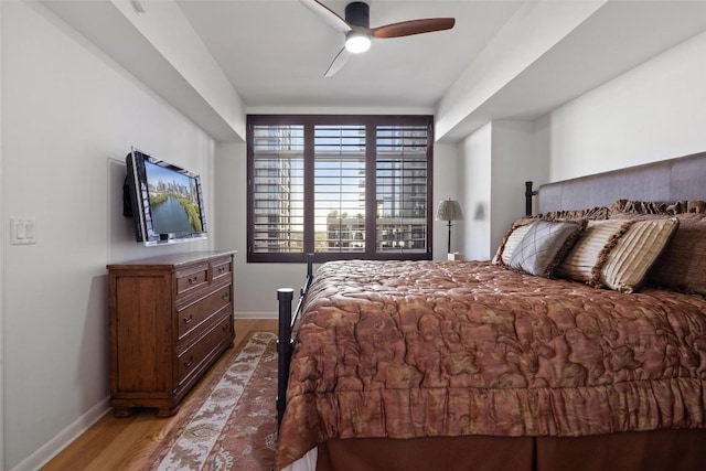 bedroom with ceiling fan and light hardwood / wood-style floors