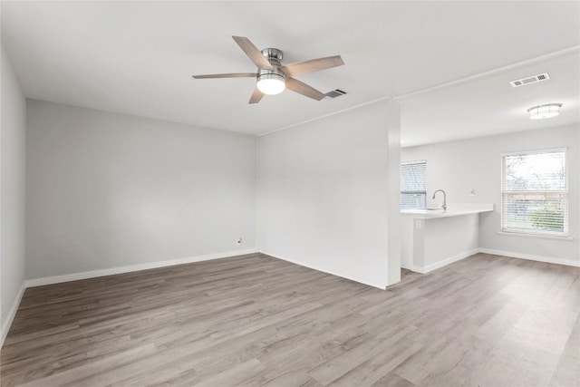 7607 Creston Ln, Austin, TX 78752 - unfurnished living room with wood finished floors and a ceiling fan