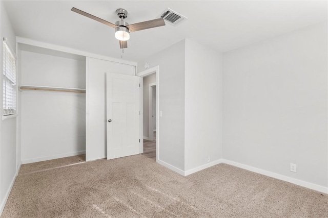 unfurnished bedroom with a closet, ceiling fan, and carpet flooring