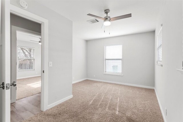 7607 Creston Ln, Austin, TX 78752 - empty room featuring light colored carpet, a ceiling fan, and baseboards