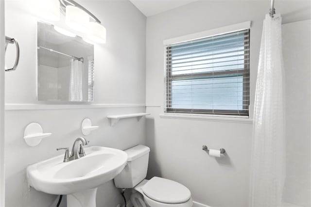 bathroom with sink, toilet, and a shower with shower curtain