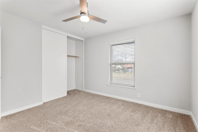 spare room featuring carpet floors and ceiling fan