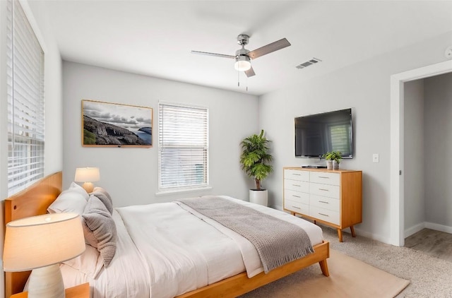 7607 Creston Ln, Austin, TX 78752 - bedroom featuring light carpet, ceiling fan, and baseboards