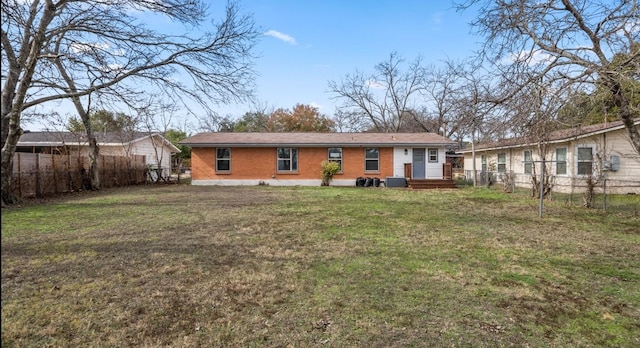 back of property featuring cooling unit and a lawn