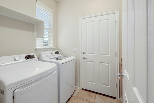 washroom featuring light tile patterned flooring and washer and dryer