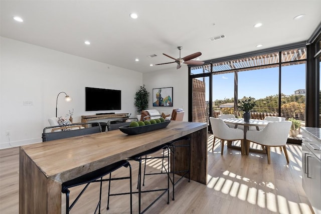 interior space with ceiling fan and light wood-type flooring