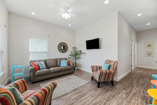 living room with ceiling fan and light hardwood / wood-style floors