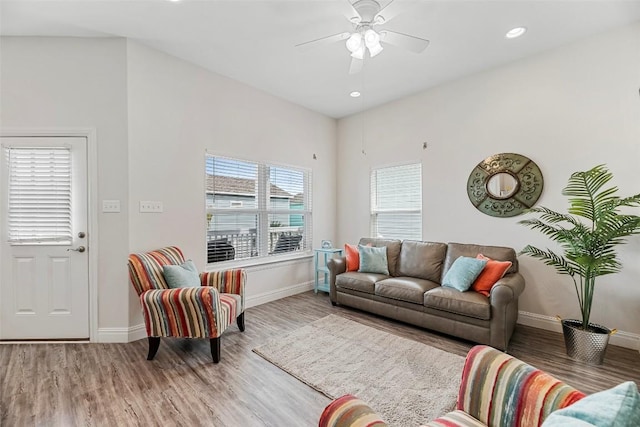 living room featuring hardwood / wood-style floors and ceiling fan