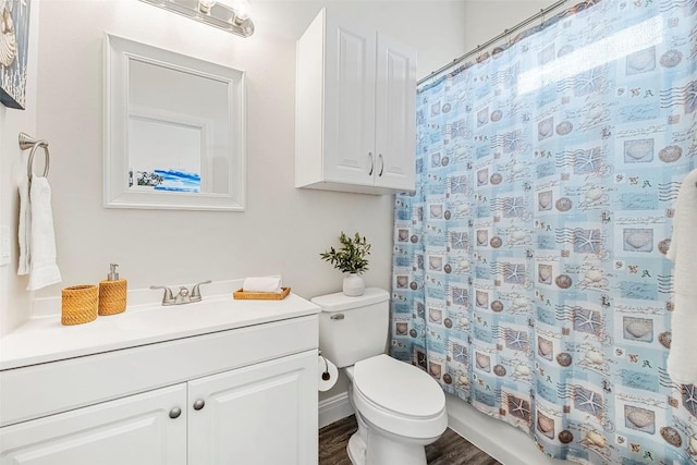 bathroom with hardwood / wood-style flooring, vanity, and toilet