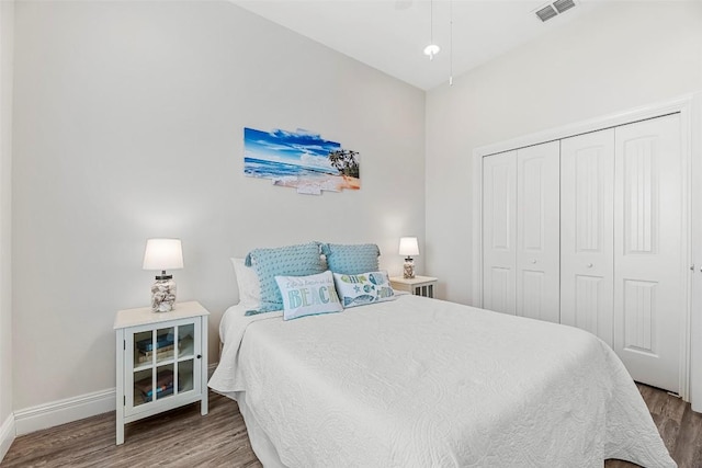 bedroom with hardwood / wood-style floors and a closet