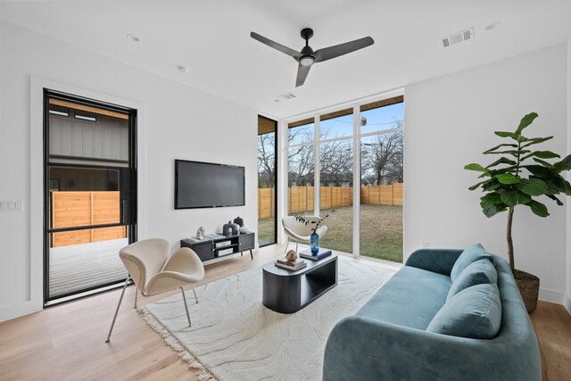 1409 Valleyridge Dr Unit B, Austin, TX 78704 - living area featuring healthy amount of natural light, wood finished floors, ceiling fan, and a wall of windows