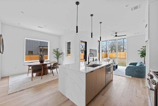 1409 Valleyridge Dr Unit B, Austin, TX 78704 - kitchen featuring appliances with stainless steel finishes, open floor plan, modern cabinets, light wood-type flooring, and recessed lighting