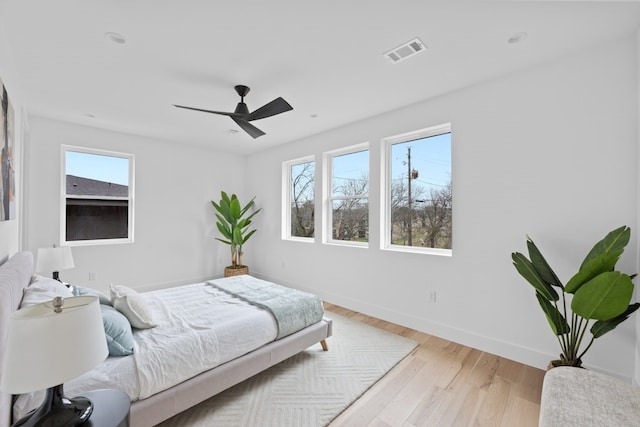 bedroom with light hardwood / wood-style floors and ceiling fan