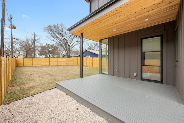 wooden terrace featuring a lawn