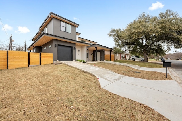 contemporary home with a garage and a front yard