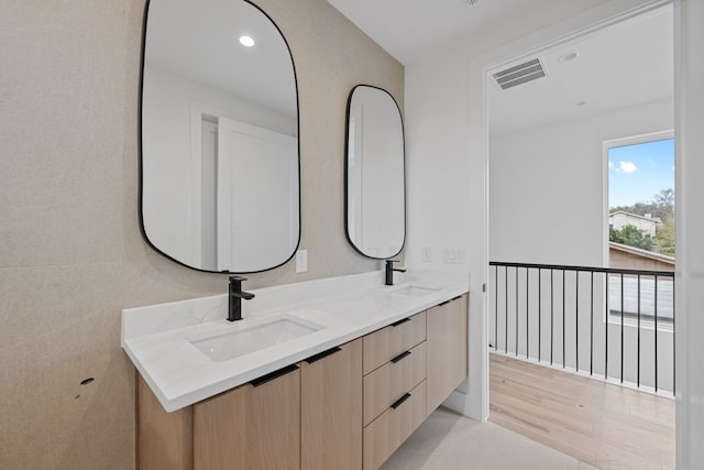 1409 Valleyridge Dr Unit B, Austin, TX 78704 - full bathroom featuring double vanity, recessed lighting, and wood finished floors