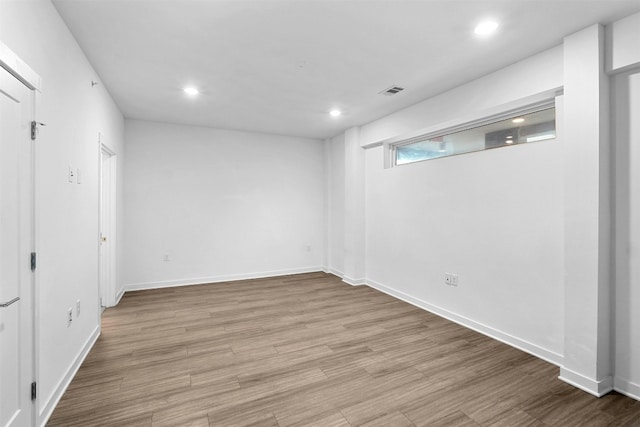 basement with light hardwood / wood-style floors