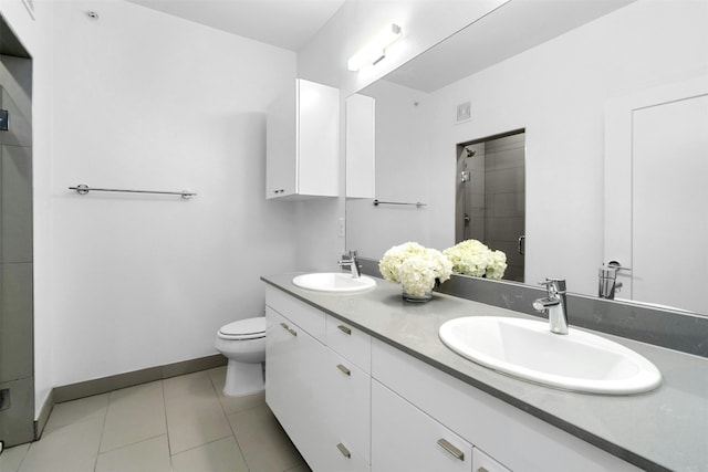 4361 S Congress Ave Unit 333, Austin, TX 78745 - full bathroom featuring double vanity, a stall shower, and tile patterned flooring
