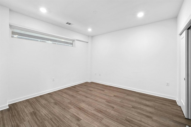 unfurnished room with dark hardwood / wood-style flooring