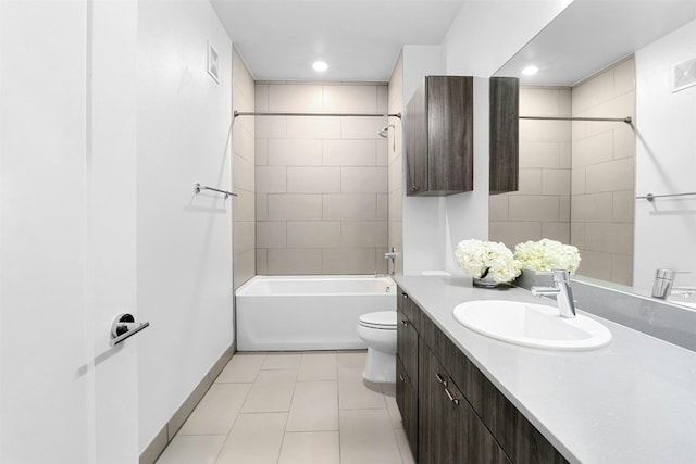 full bathroom with tile patterned floors, vanity, toilet, and tiled shower / bath combo